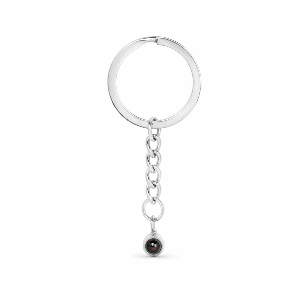 Personalised circle photo projection keyring in silver showing hidden photo inside lens