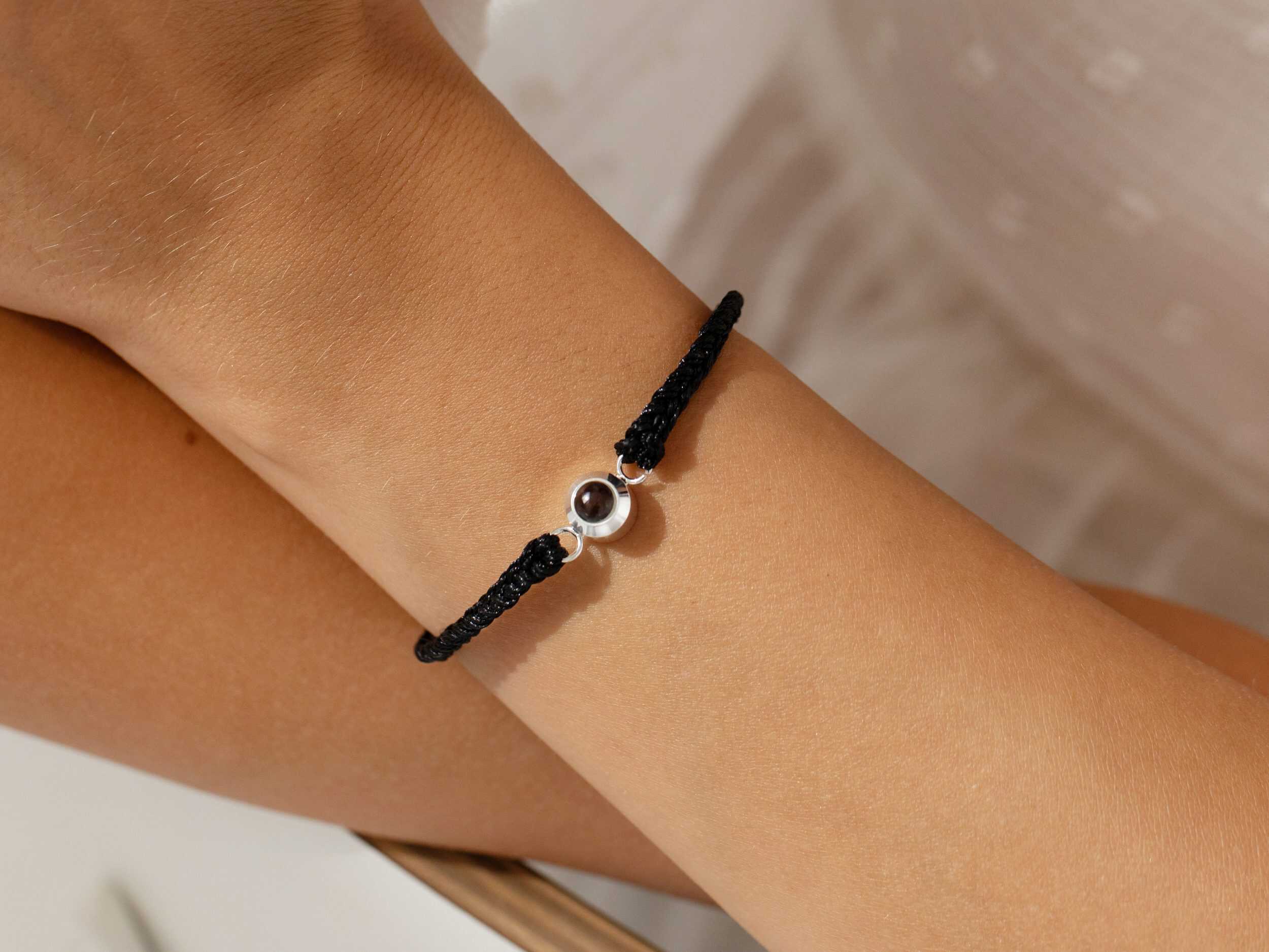 Silver photo projection bracelet on wrist