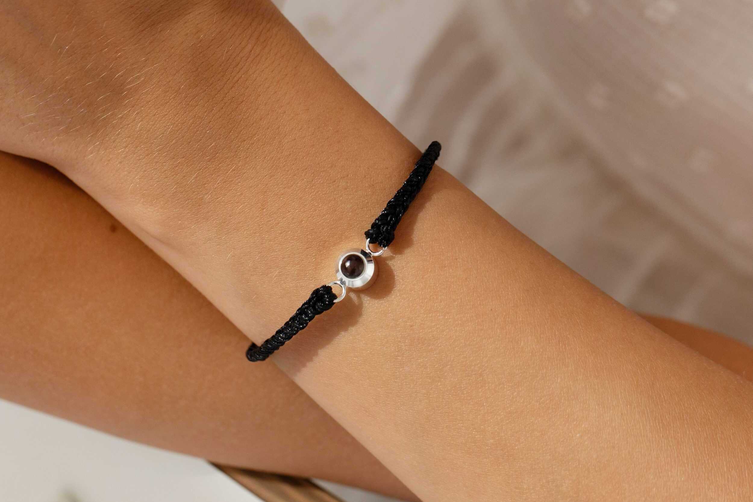 Silver photo projection bracelet on wrist