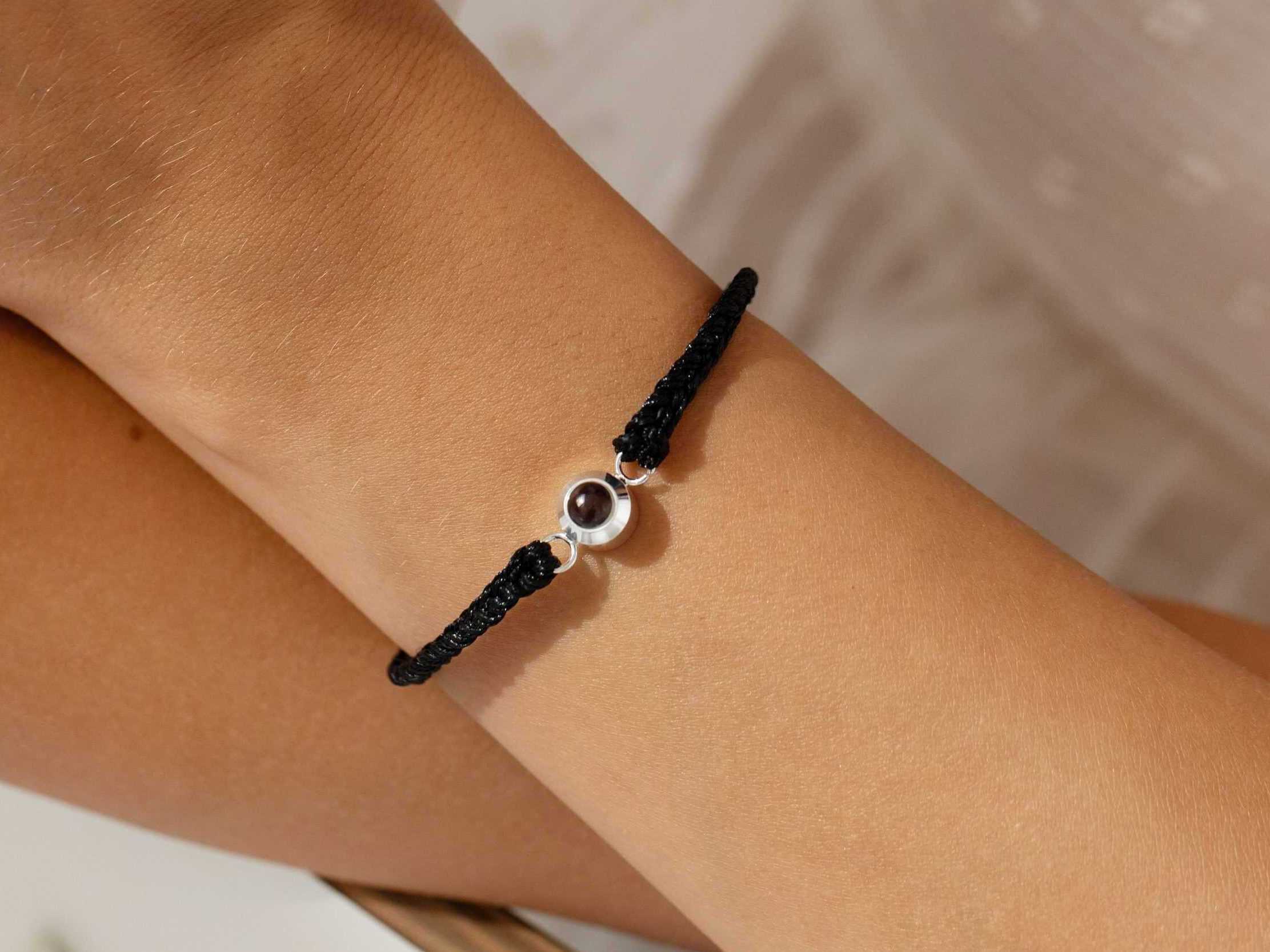 Silver photo projection bracelet on wrist