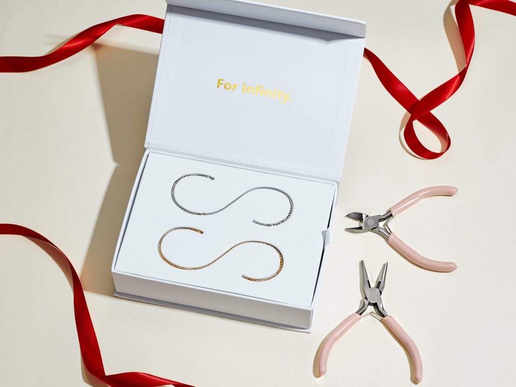 An at-home permanent bracelet kit chain being fitted to a wrist