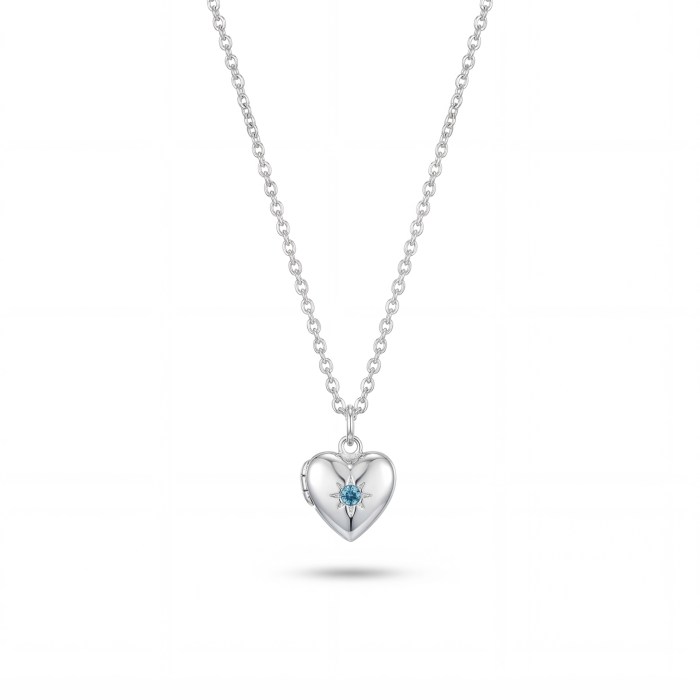Silver heart pendant necklace with a blue gemstone, hanging from a chain against a white background.