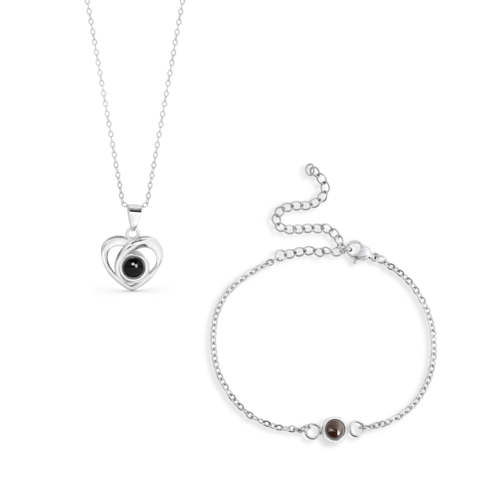 Silver heart pendant necklace with a black gemstone centerpiece on a delicate chain.