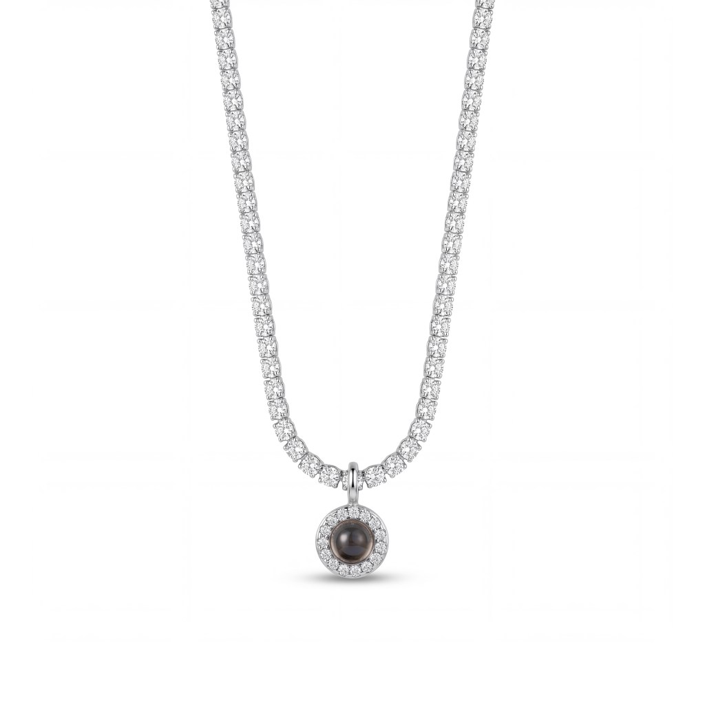 Diamond tennis necklace with round-cut stones along a slim chain and a circular pendant featuring a central dark gemstone surrounded by diamonds.